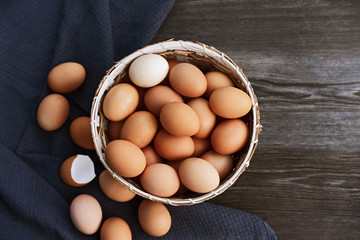 Healthy and benefits of chicken egg..Many chicken eggs in basket on wooden background.