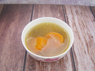 Chinese tableware carrot stew chicken soup on wooden board