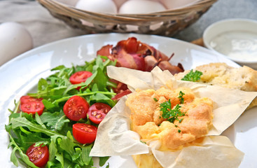 Healthy and benefits breakfast with egg menu..Mini muffin Soufflé Omelette with Salad and crispy bacon.