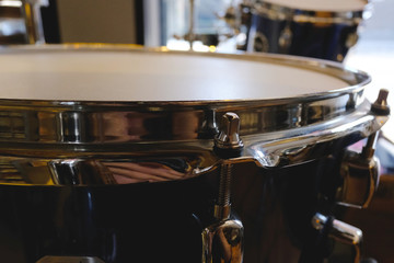 Fototapeta na wymiar Close up of snare drum and blured tom background, Drumset is it a instruments for drummer musician, percussion rythm equipment. with selective focus