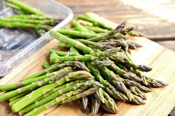A lot of fresh Green Asparagus (genus) on wooden floor