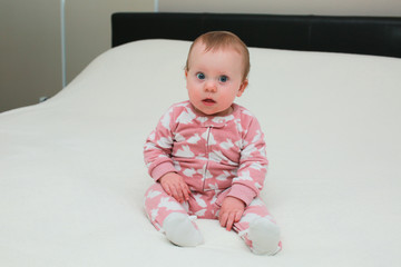 Fototapeta premium Close up Portrait of Cute Little 9 Month Old Baby Girl , with sticker