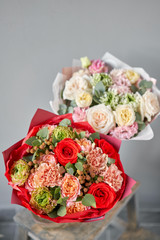 European floral shop. Beautiful bouquet of mixed flowers in glas vase. the work of the florist at a flower shop. Delivery fresh cut flower.