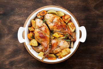 Stewed in white wine with spices rabbit legs with baked vegetables and rosemary.