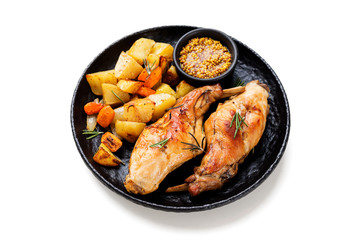 Stewed in white wine with spices rabbit legs with baked vegetables and rosemary. isolated on white background