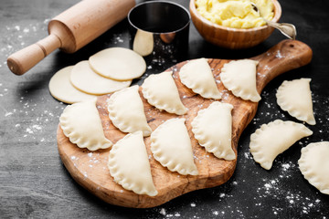 Homemade raw dumpling with potatoes. Preparation dumplings with mashed potatoes .