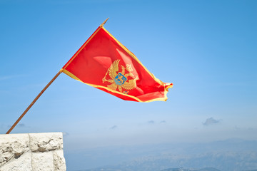 Flag of Montenegro is flying over Lovcen national park.