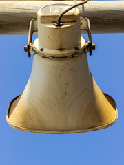 Fototapeta premium loud speaker, siren attached to a wooden pole