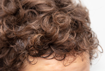 Curly hair on the boy head.