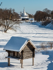 Wooden barns on stilts. Winter landscape. Museum of wooden architecture in Suzdal. Golden Ring of Russia.