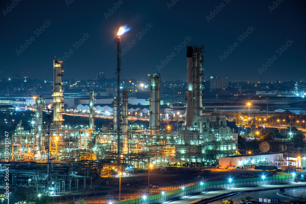 Wall mural oil refinery and natural gas storage tank at night