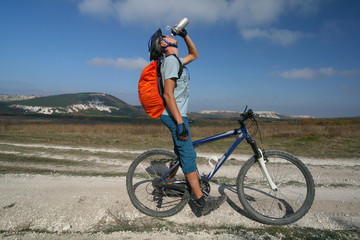 Cyclist on the background of the Crimean mountains, Russia.