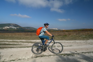 Fototapeta na wymiar Cyclist on the background of the Crimean mountains, Russia.