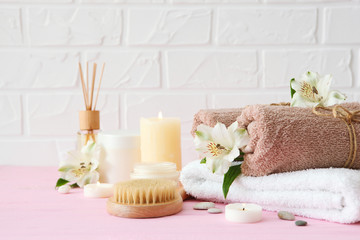 Obraz na płótnie Canvas spa composition with towels and flowers on the table with place for text. Body care, relaxation
