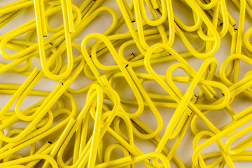 Yellow paperclips close-up, top view