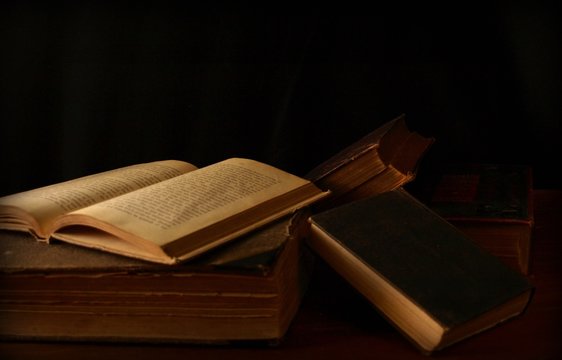 Antique Books Loosely Stacked Photographed in Chiaroscuro Style 