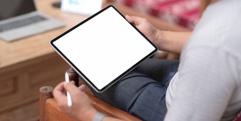 Cropped shot of businessman using blank screen tablet