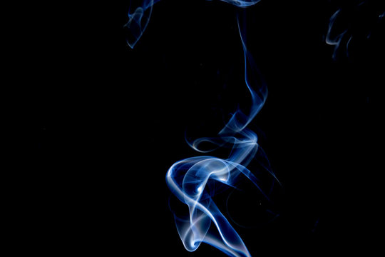 Abstract motion of white smoke isolated on a black background Can be modeled as hot food, smog, small clouds, and aromatic smoke.