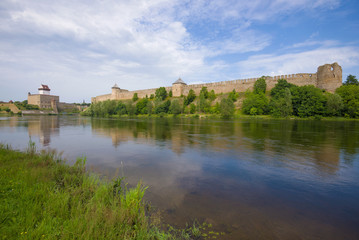 Fototapeta na wymiar Summer landscape with Ivangorod fortress and Herman's castle. The border of Estonia and Russia
