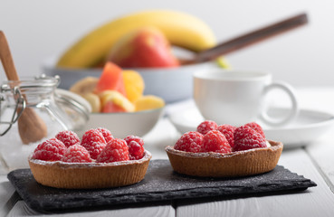 2 small raspberry cakes on a black slate
