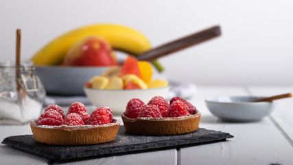 2 small raspberry cakes on a black slate