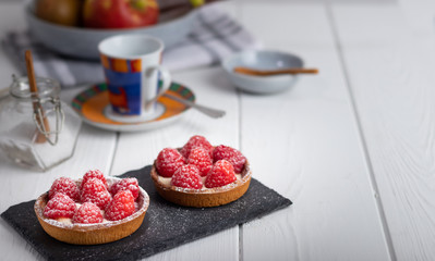 2 small raspberry cakes on a black slate