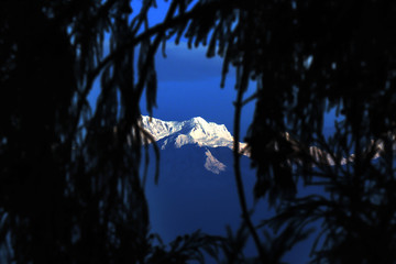 Kanchanjungha during golden hour, snow, peak, landscape, nature, Himalayan. Snowy mountains of Himalaya. A beautiful snowy mountain landscape under a blue cloudy sky..