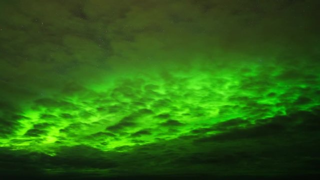 Time lapse of northern lights (aurora borealis) behind clouds in Norway