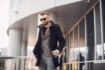 Man in a stylish suit. Businessman in a summer city