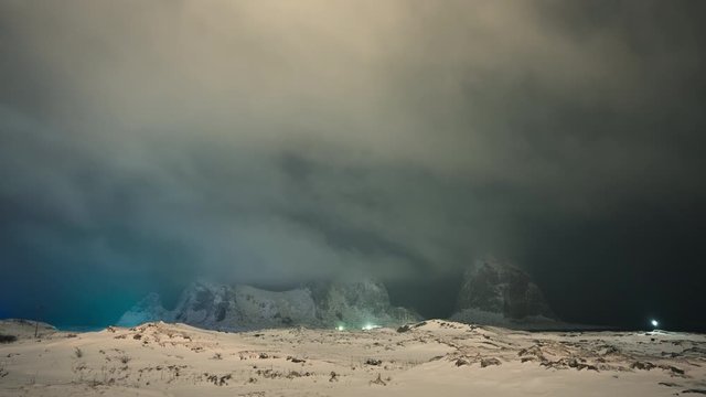 Night time lapse of clouds over iconic mountains of Sanna in Tr&aelig;na archipelago, Nordland, Norway