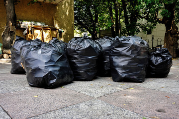 Action on separate collection of waste, black bags with garbage. Environmental pollution. Ecology.