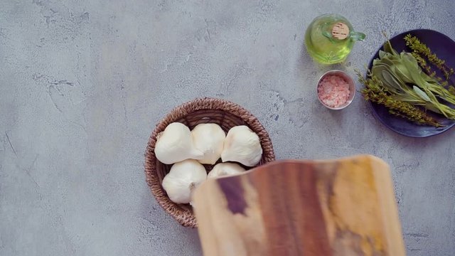 Flat lay. Preparing garlic spread by roasting garlic with fresh spices in cast iron frying pan.