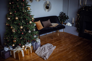 Beautiful modern gray apartment room, decorated for New Year and Christmas.