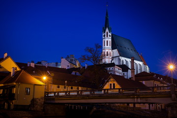 Catholic church of St. Vitus and Vltava river at night. Historical center of Cesky Krumlov. Czech republic.