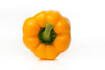Fresh yellow pepper is isolated on a white background.