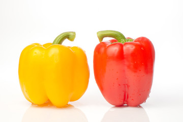Two red and yellow Fresh pepper are isolated in  white background.