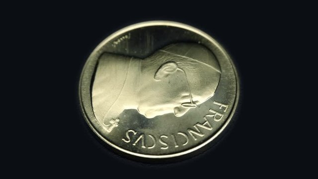 Commemorative medal token, ROMA, FRANCISCVS rotates on a black background. Macro. Closeup