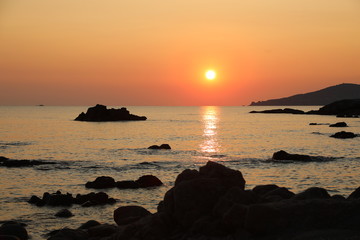 Red Sun at sunset with ocean