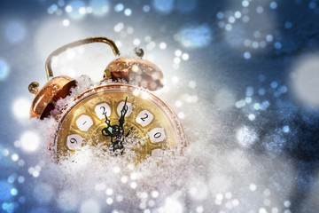 Happy New Year concept, vintage alarm clock in the snow shows 2020, greeting card with copy space