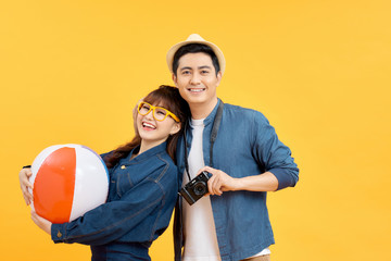 Lovely Asian couple in summer casual clothes and beach accessories studio shot isolated