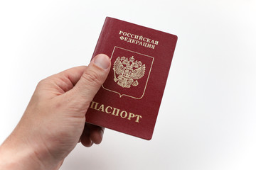 Hand with Russian passport on white background.