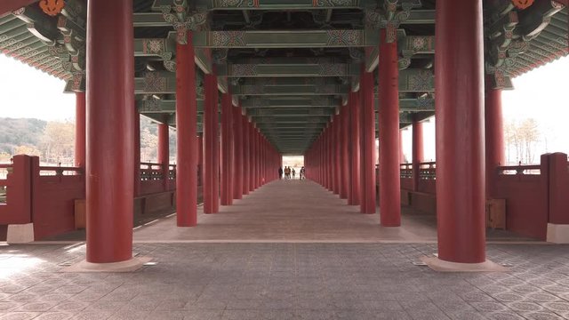 Scenic cinematic slow motion video of Woljeonggyo Bridge over Hyeongsan River in Gyeongju in South Korea. Beautiful summer cloudy look of colorful traditional asian style bridge in Republic of Korea.