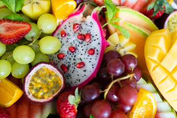 close up sliced assorted fresh tropical fruits platter,use a background