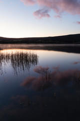 Epic vibrant sunrise Autumn Fall landscape image of Ullswater in Lake District with golden sunlight