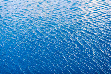 Water waves surface background. Aqua background texture. Abstract water ripples selective focus. Design element for banner and artwork