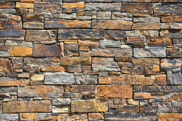 Texture of decorative stone wall with uneven edges and different shades