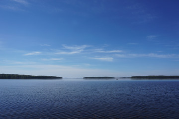 summer weather and rowboat on the horizon