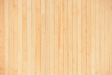 Fototapeta na wymiar Texture of a light yellow wooden wall of planks without painting. New and fresh wooden wall