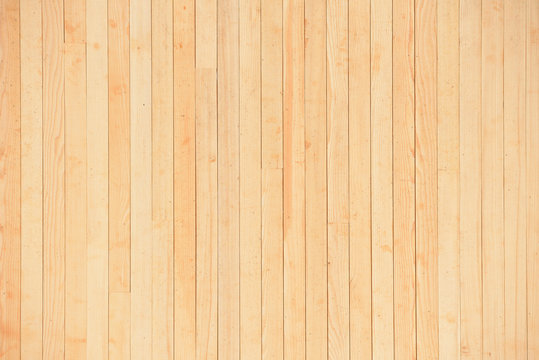 Texture of a light yellow wooden wall of planks without painting. New and fresh wooden wall