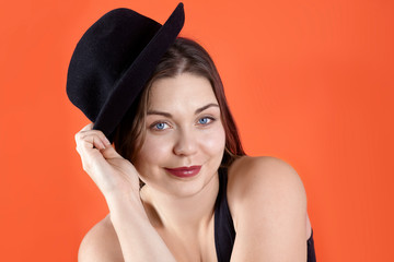Young attractive caucasian brunette woman with bright blue eyes and dark lipstick, in casual black...